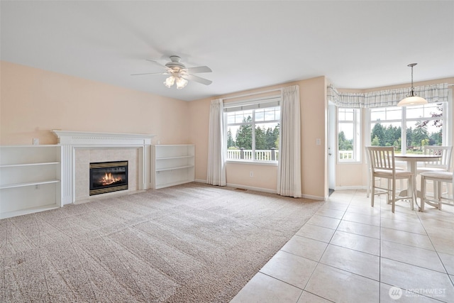 22019 84th Avenue Ct E, Graham, WA 98338 - unfurnished living room with ceiling fan, a tile fireplace, tile patterned flooring, and carpet