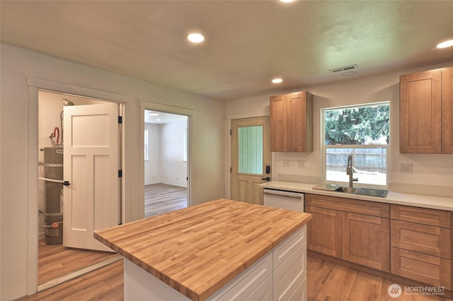 307 Portage Ave, Granite Falls, WA 98252 - kitchen with wooden counters, white dishwasher, secured water heater, recessed lighting, and light wood finished floors