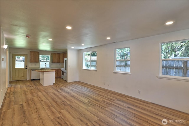 307 Portage Ave, Granite Falls, WA 98252 - kitchen with open floor plan, light wood finished floors, recessed lighting, a kitchen island, and dishwasher