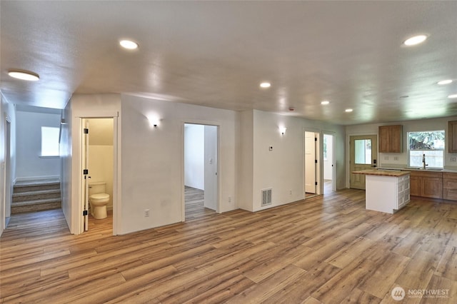307 Portage Ave, Granite Falls, WA 98252 - unfurnished living room featuring light wood-style floors, stairs, and recessed lighting