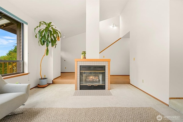 1708 Whatcom St, Bellingham, WA 98229 - carpeted living room featuring a tiled fireplace and baseboards