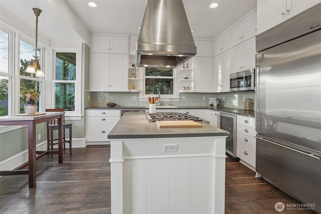 4117 44th Ave SW, Seattle, WA 98116 - kitchen featuring appliances with stainless steel finishes, island range hood, open shelves, wine cooler, and dark countertops