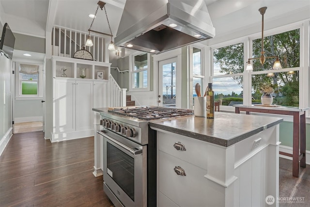 4117 44th Ave SW, Seattle, WA 98116 - kitchen featuring high end stove, island exhaust hood, dark wood finished floors, white cabinets, and hanging light fixtures