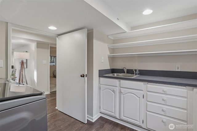4117 44th Ave SW, Seattle, WA 98116 - kitchen with open shelves, dark countertops, white cabinetry, and dark wood-style floors