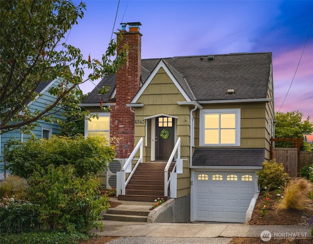 6543 12th Ave NW, Seattle, WA 98117 - view of front of house featuring an attached garage, a chimney, a shingled roof, and concrete driveway