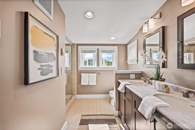 6543 12th Ave NW, Seattle, WA 98117 - bathroom with double vanity, an enclosed shower, and recessed lighting
