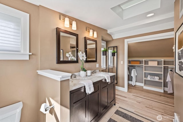 6543 12th Ave NW, Seattle, WA 98117 - bathroom featuring double vanity and wood finished floors