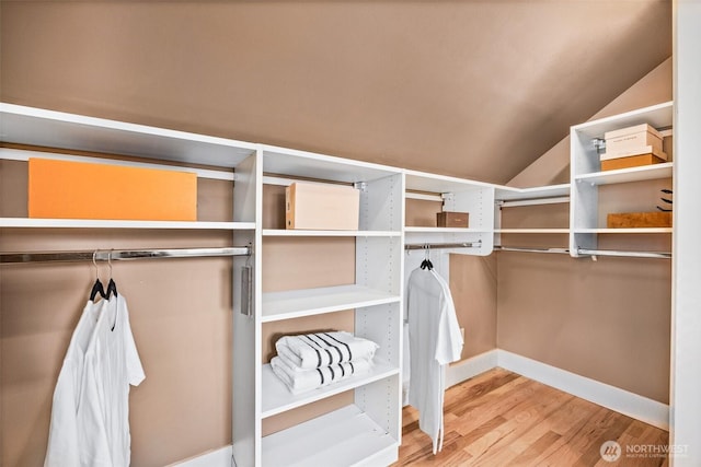 6543 12th Ave NW, Seattle, WA 98117 - walk in closet featuring wood finished floors and lofted ceiling