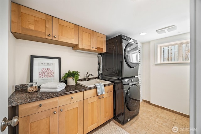6543 12th Ave NW, Seattle, WA 98117 - laundry area featuring stacked washer / dryer, cabinet space, light tile patterned floors, and recessed lighting