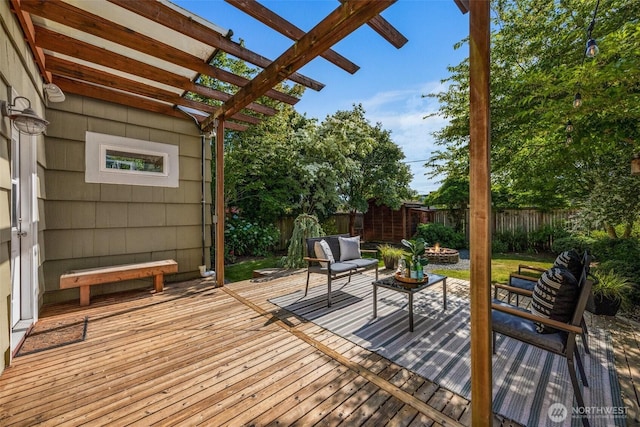 6543 12th Ave NW, Seattle, WA 98117 - wooden terrace with an outdoor fire pit, a fenced backyard, and a pergola