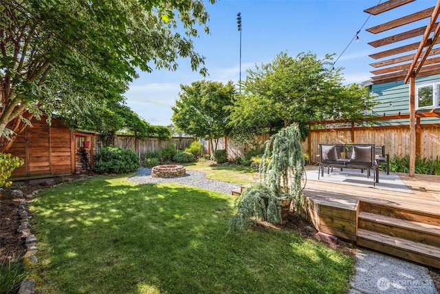 6543 12th Ave NW, Seattle, WA 98117 - fenced backyard with an outdoor fire pit and a wooden deck