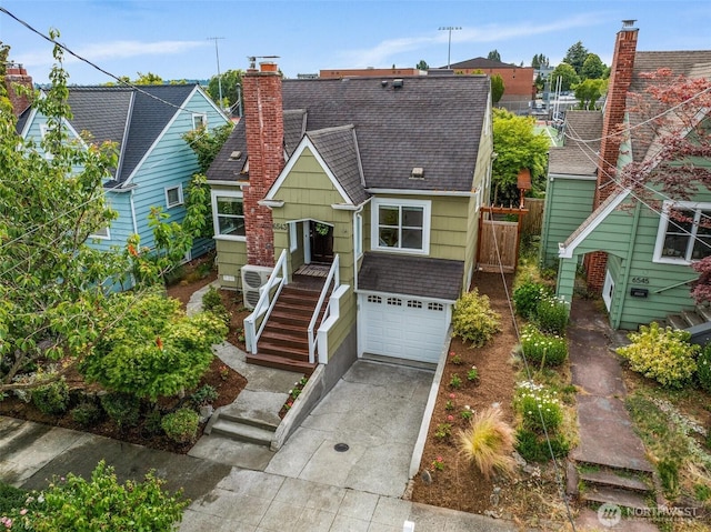 6543 12th Ave NW, Seattle, WA 98117 - view of front of house featuring concrete driveway, an attached garage, roof with shingles, stairs, and a chimney