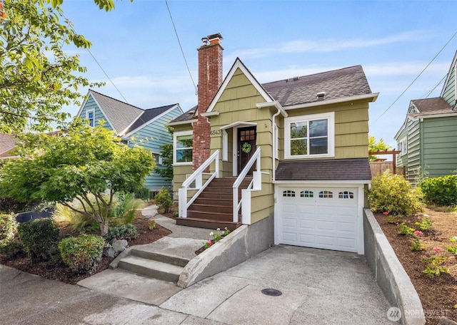 6543 12th Ave NW, Seattle, WA 98117 - view of front of home featuring concrete driveway, a garage, roof with shingles, and a chimney