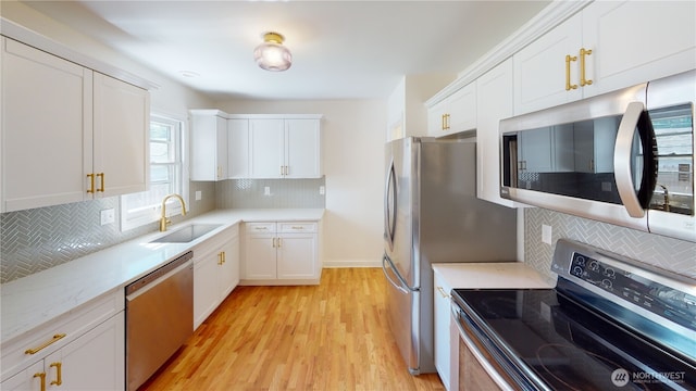 1303 Modoc, Walla Walla, WA 99362 - kitchen featuring appliances with stainless steel finishes, decorative backsplash, light wood-style flooring, and white cabinetry