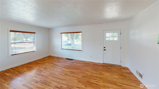 1303 Modoc, Walla Walla, WA 99362 - entrance foyer featuring light wood-type flooring, crown molding, and a textured ceiling