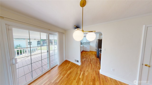 1303 Modoc, Walla Walla, WA 99362 - unfurnished dining area featuring light wood-style flooring and crown molding