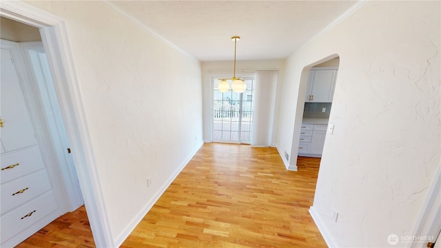 1303 Modoc, Walla Walla, WA 99362 - hallway featuring light wood-style flooring, arched walkways, and crown molding
