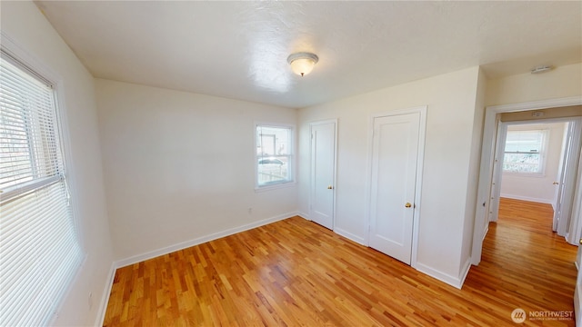 1303 Modoc, Walla Walla, WA 99362 - unfurnished bedroom featuring multiple windows and light wood-type flooring