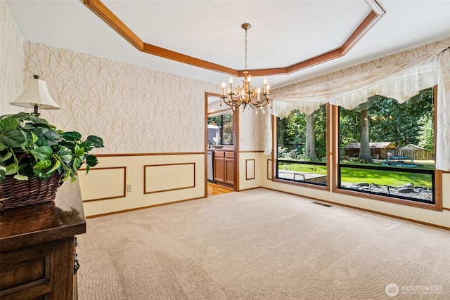 24131 SE 225th St, Maple Valley, WA 98038 - empty room featuring wallpapered walls, light colored carpet, a wainscoted wall, a chandelier, and a tray ceiling