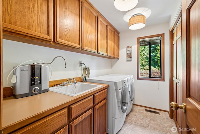 24131 SE 225th St, Maple Valley, WA 98038 - washroom with cabinet space, washing machine and clothes dryer, and light tile patterned flooring