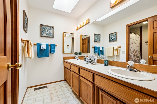 24131 SE 225th St, Maple Valley, WA 98038 - bathroom featuring a skylight and double vanity