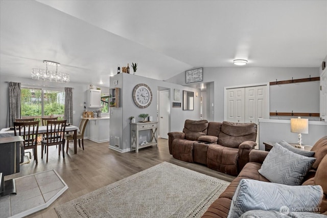 35728 157th Pl SE, Sultan, WA 98294 - living area featuring lofted ceiling, wood finished floors, and a chandelier