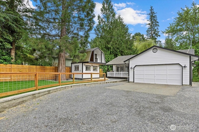 35728 157th Pl SE, Sultan, WA 98294 - view of front of house with gravel driveway, a gambrel roof, roof with shingles, and a garage