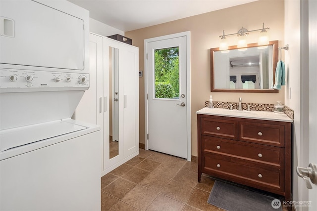 23318 3rd Pl W, Bothell, WA 98021 - washroom featuring stacked washing machine and dryer and dark tile patterned floors