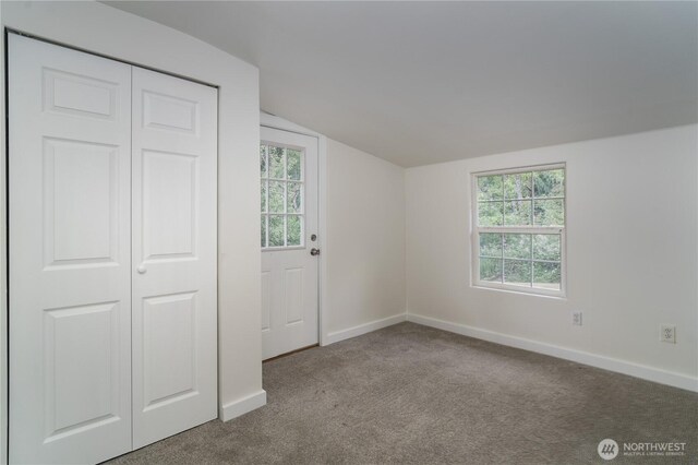 21405 Thompson Creek Rd SE, Tenino, WA 98589 - unfurnished bedroom with vaulted ceiling, carpet floors, and a closet