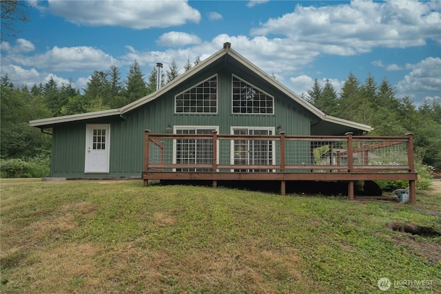21405 Thompson Creek Rd SE, Tenino, WA 98589 - rear view of property with a deck, a yard, and board and batten siding