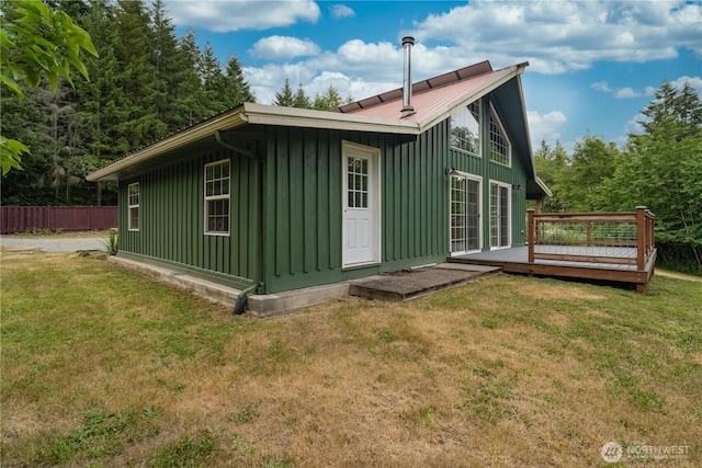 21405 Thompson Creek Rd SE, Tenino, WA 98589 - rear view of house featuring board and batten siding, a wooden deck, and a metal roof