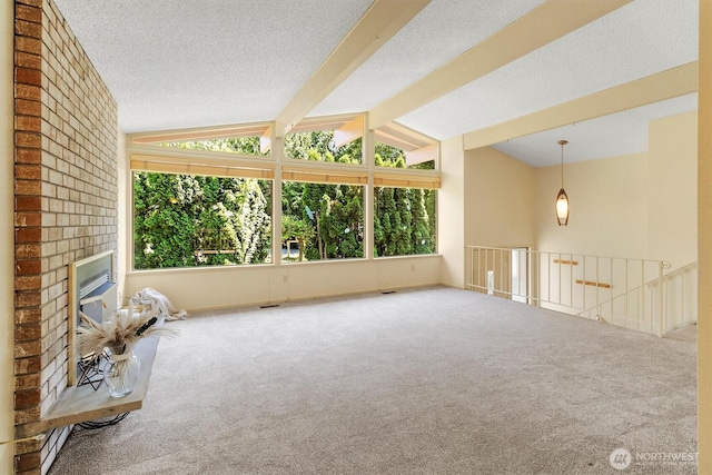 3909 Fielding Ave, Bellingham, WA 98229 - carpeted spare room with healthy amount of natural light, a brick fireplace, and a textured ceiling
