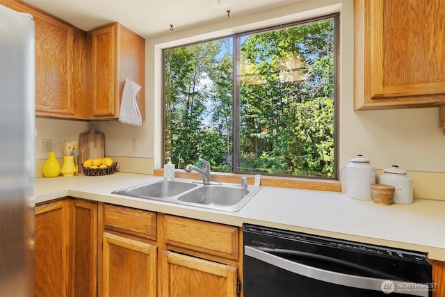 3909 Fielding Ave, Bellingham, WA 98229 - kitchen featuring dishwasher, light countertops, freestanding refrigerator, and brown cabinets