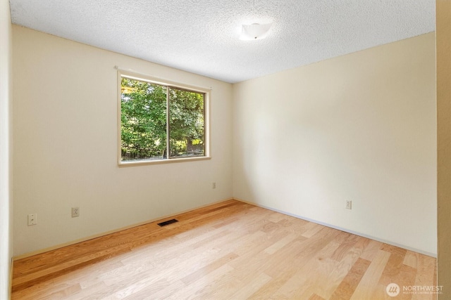 3909 Fielding Ave, Bellingham, WA 98229 - unfurnished room with wood finished floors and a textured ceiling