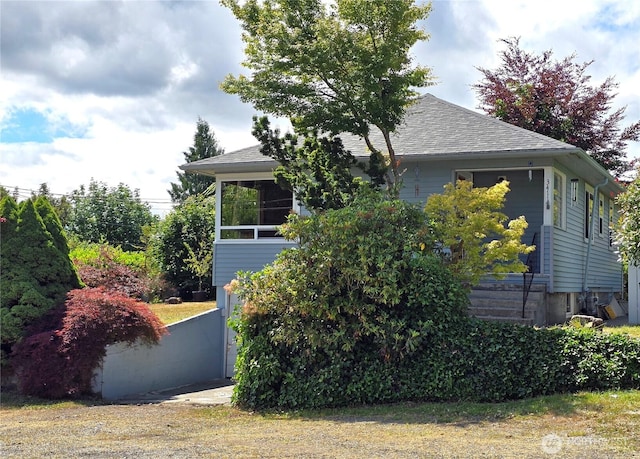3411 Preble St, Bremerton, WA 98312 - view of home's exterior featuring a shingled roof and a sunroom