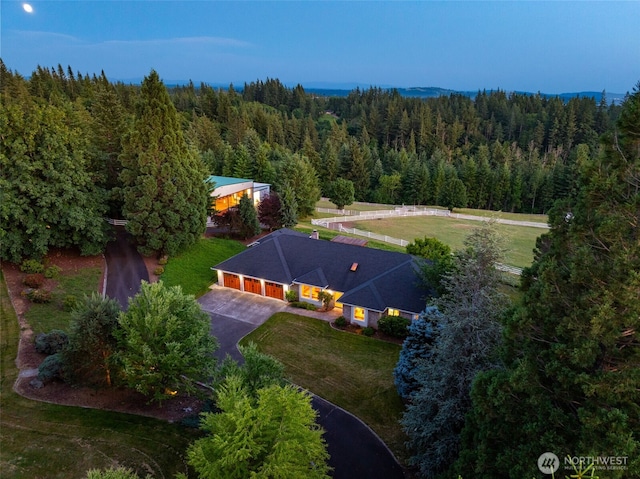 view of subject property with a forest