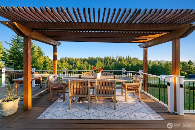 deck featuring outdoor dining space and a pergola