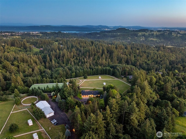 view of property location featuring a forest