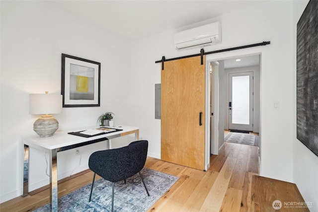 511 Howe St Unit C, Seattle, WA 98109 - office area featuring a wall unit AC, a barn door, and light wood-type flooring