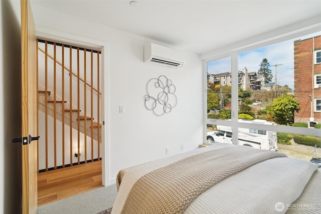 511 Howe St Unit C, Seattle, WA 98109 - bedroom with an AC wall unit and wood finished floors