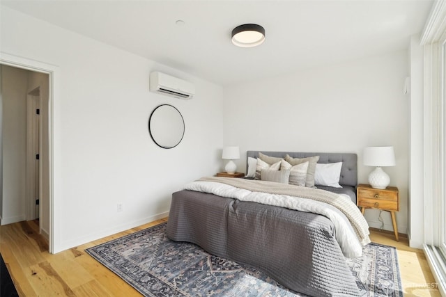 511 Howe St Unit C, Seattle, WA 98109 - bedroom featuring an AC wall unit and light wood-style floors