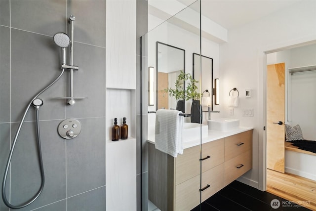 511 Howe St Unit C, Seattle, WA 98109 - bathroom with a tile shower, double vanity, and wood finished floors