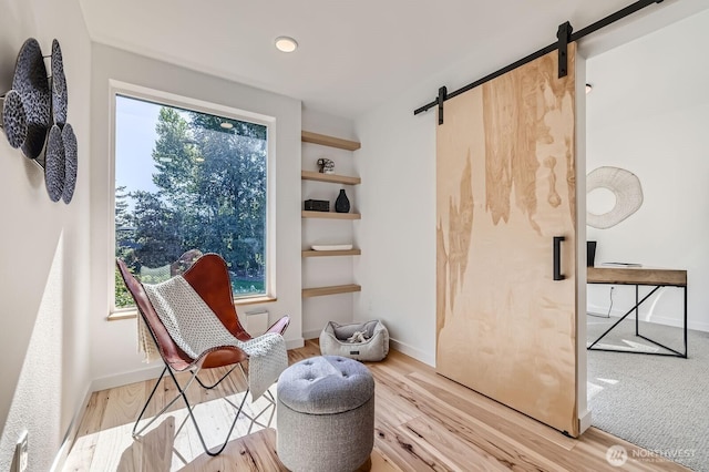 515 Howe St Unit C, Seattle, WA 98109 - sitting room featuring a barn door and wood finished floors