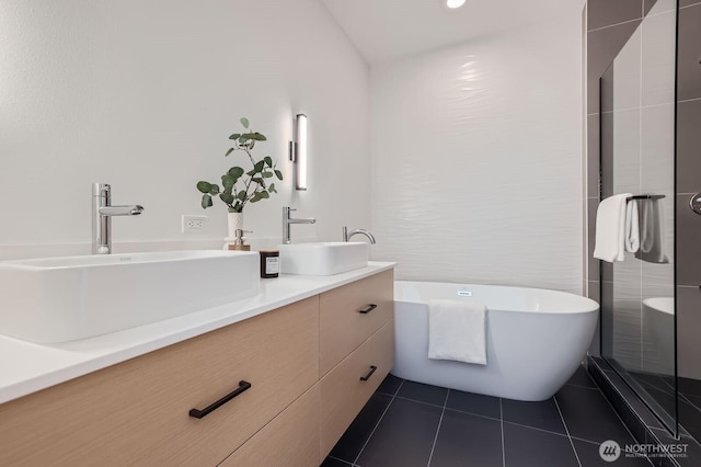 515 Howe St Unit C, Seattle, WA 98109 - bathroom featuring double vanity, a freestanding tub, and tile patterned floors