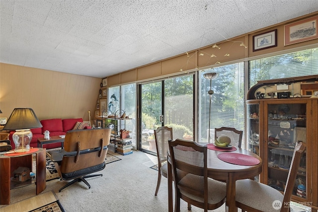 4925 Goodpiper Ln, Freeland, WA 98249 - dining room featuring carpet flooring and wooden walls