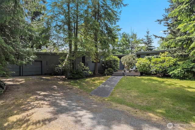 4925 Goodpiper Ln, Freeland, WA 98249 - obstructed view of property with a front yard, driveway, and an attached garage