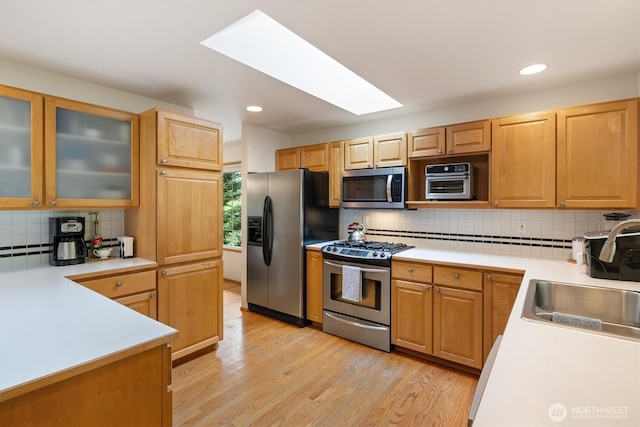 7123 NE 165th St, Kenmore, WA 98028 - kitchen featuring stainless steel appliances, decorative backsplash, light countertops, light wood-type flooring, and recessed lighting