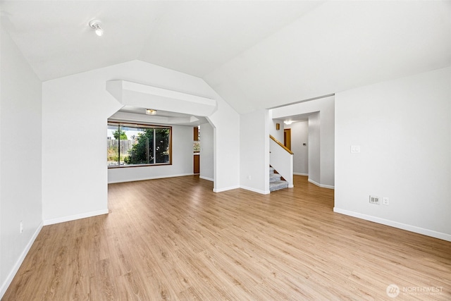 9812 S 247th Ct, Kent, WA 98030 - unfurnished living room featuring stairway, wood finished floors, and lofted ceiling