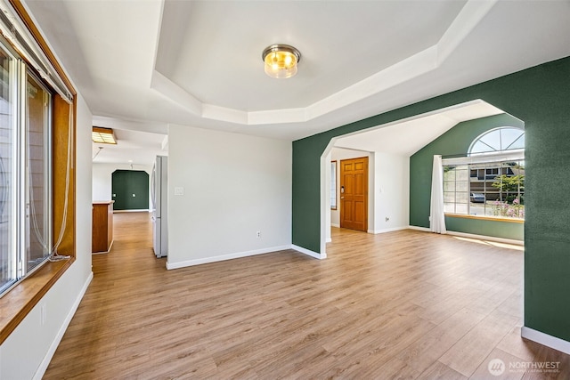 9812 S 247th Ct, Kent, WA 98030 - unfurnished room featuring arched walkways, a raised ceiling, and wood finished floors