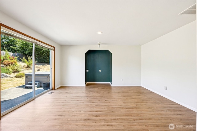 9812 S 247th Ct, Kent, WA 98030 - empty room featuring light wood finished floors, arched walkways, and recessed lighting